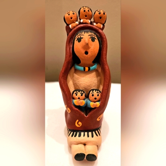 Navajo Storyteller Handcrafted Clay Figurine with Brown and Blue Accents.